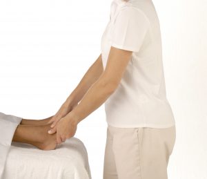 image of therapist holding feet